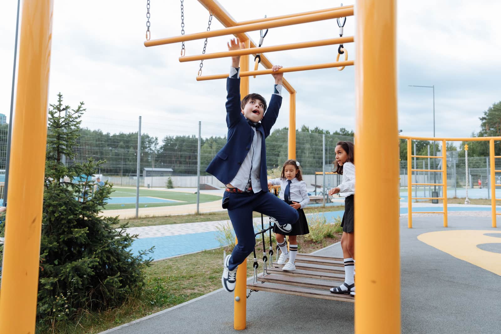 Kids crossing the monkey bars on a playground